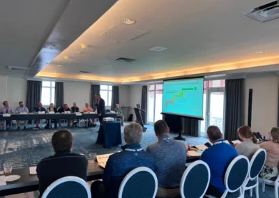 A presentation on warehousing and fulfillment services taking place in a conference room in the United States.